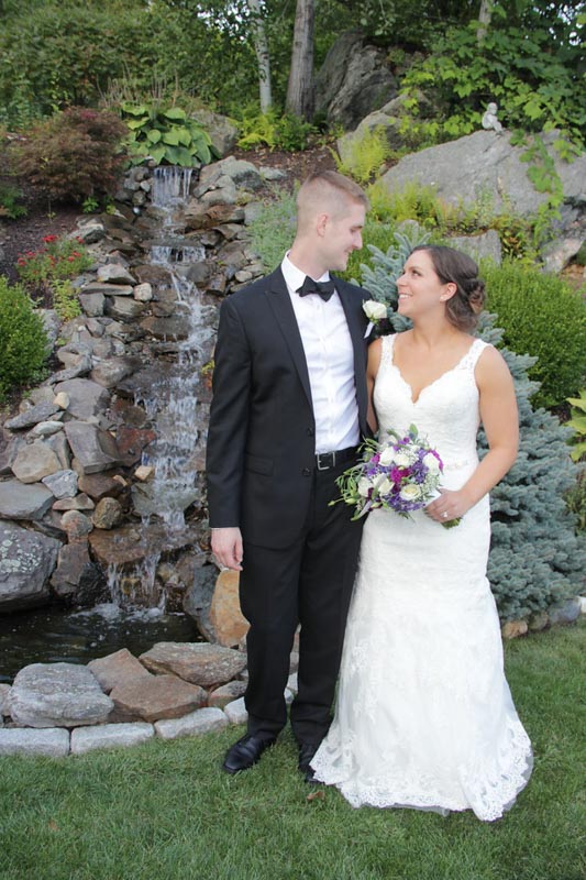 Bride and Groom Standing in Front of a Waterfall