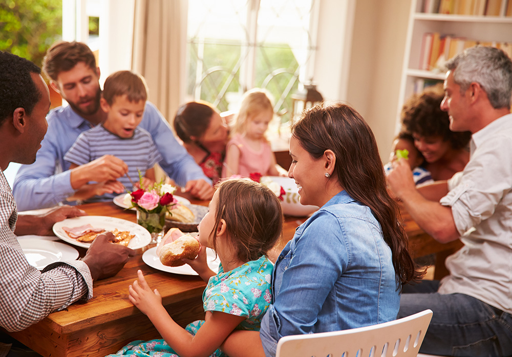 Family and Friends Eating at Table